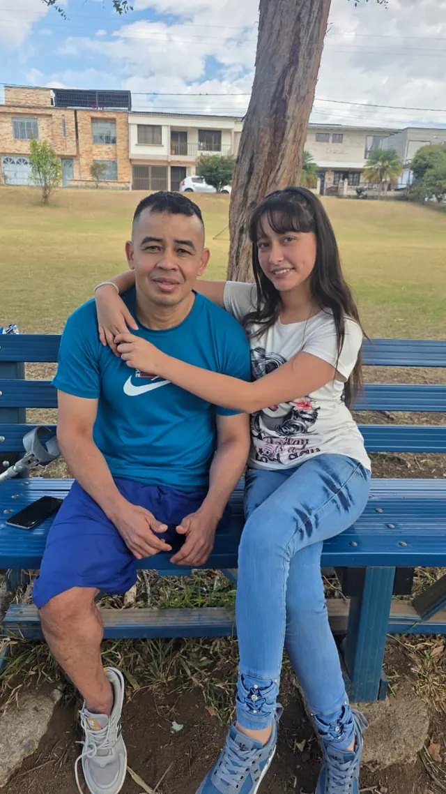 Nando with a close family member on a park bench